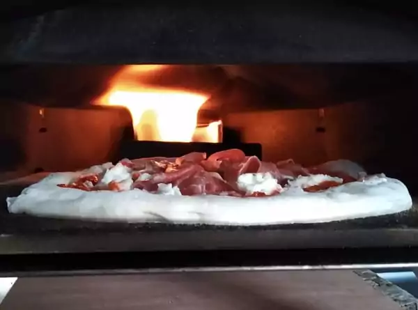 Using a laser thermometer when cooking in a pizza oven is one of the best homemade pizza tips