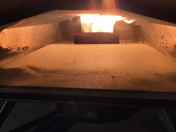 flames cleaning and seasoning the pizza stone