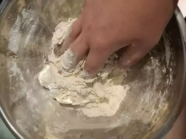 Mixing pizza dough by hand