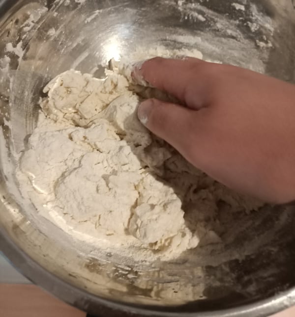 Mixing sugar in pizza dough