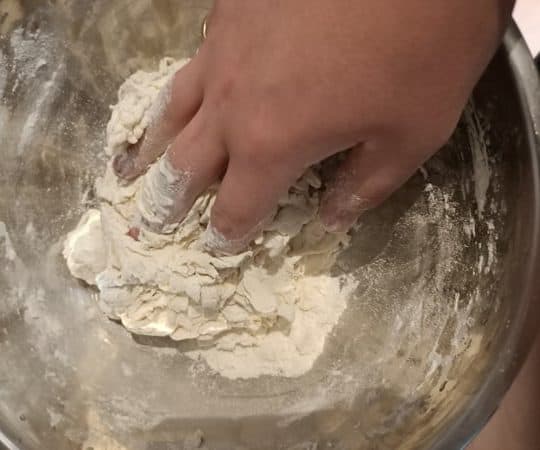 Mixing pizza dough by hand