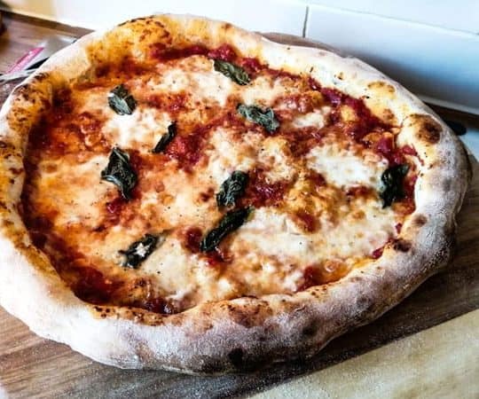 Cooked Neapolitan pizza on peel