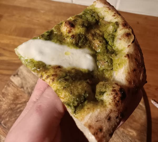 Pesto pizza slice