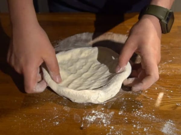 Turning the pizza dough