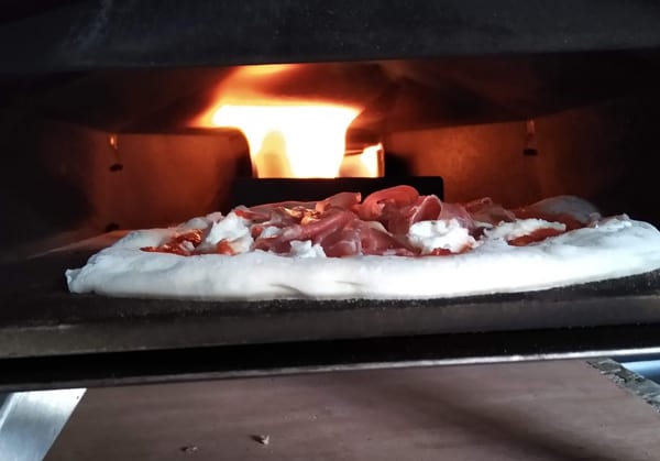 Pizza cooking in pizza oven